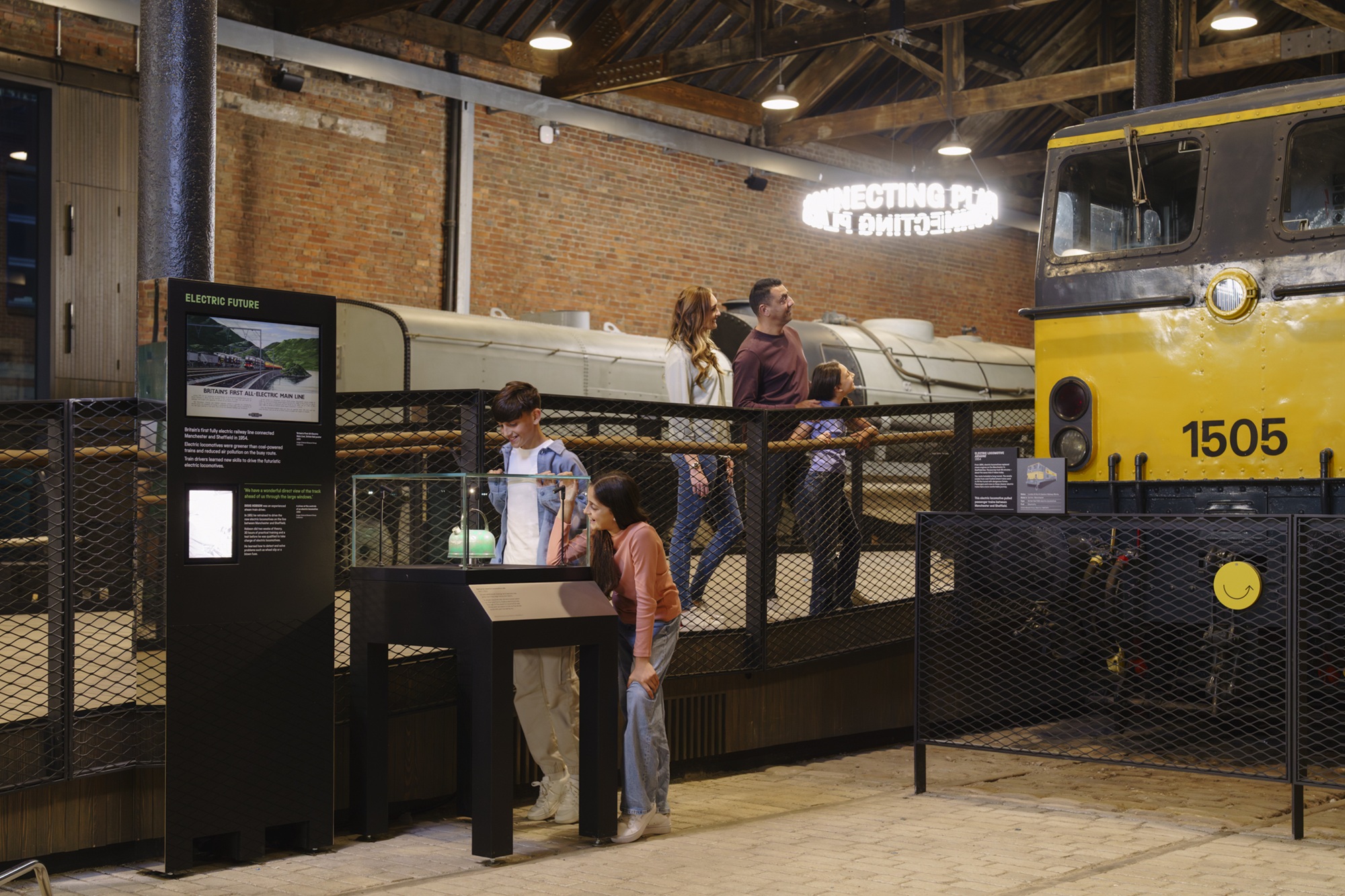 Family looking at a locomotive and display in Power Hall