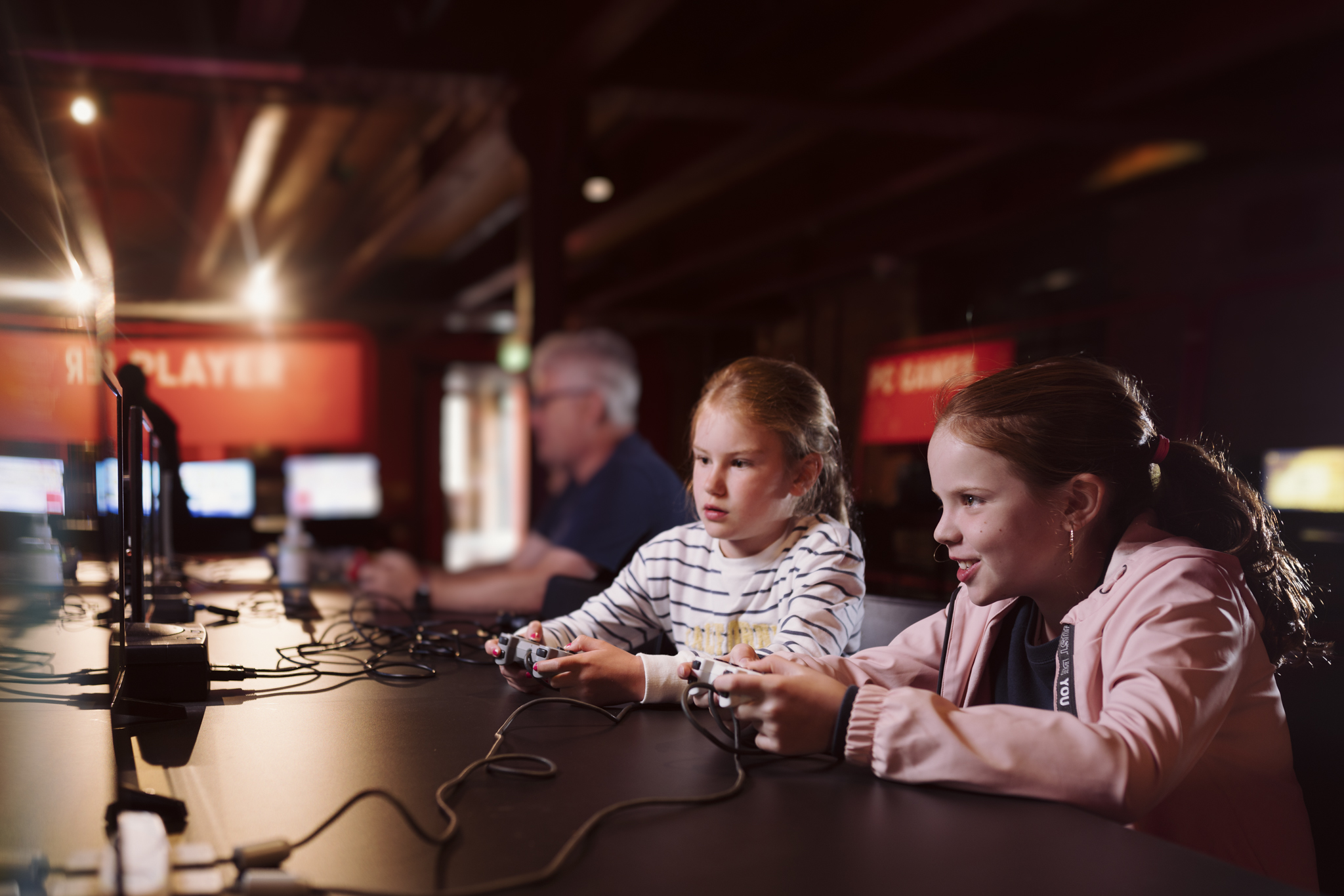 Two children holding controllers in Power Up