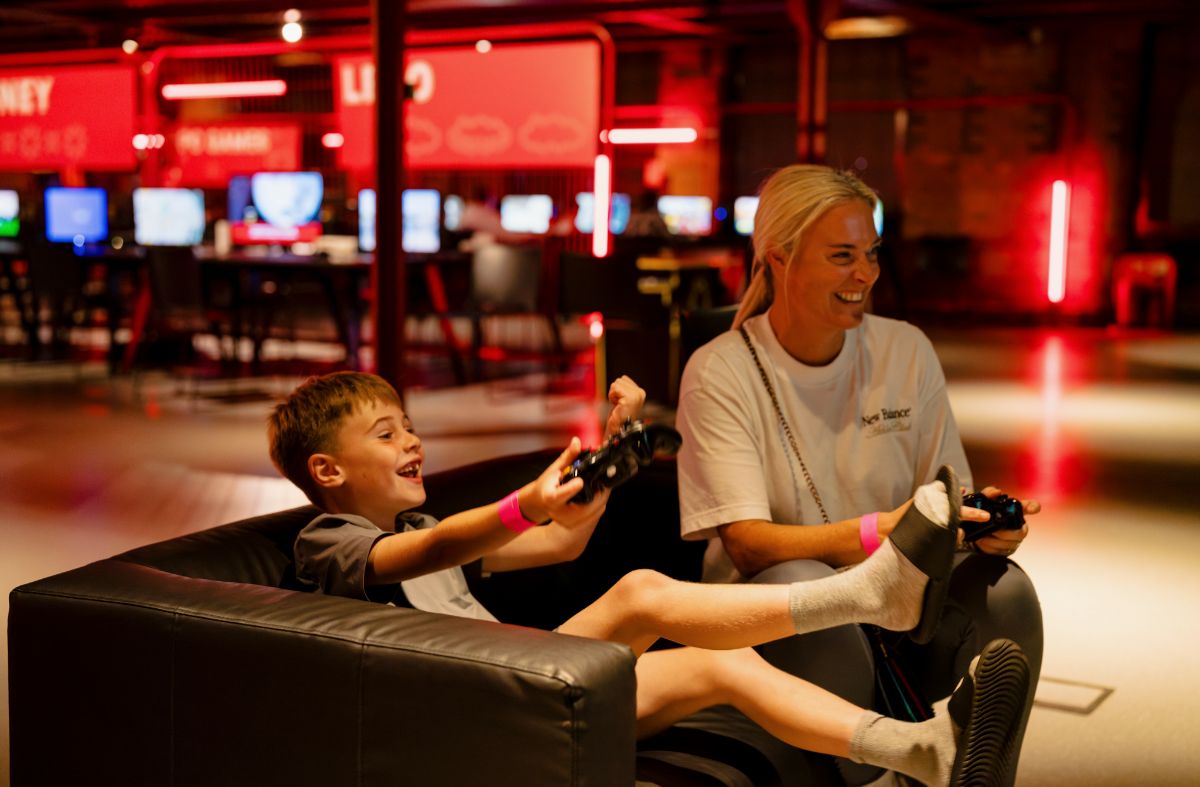 A mother and son playing a video game together