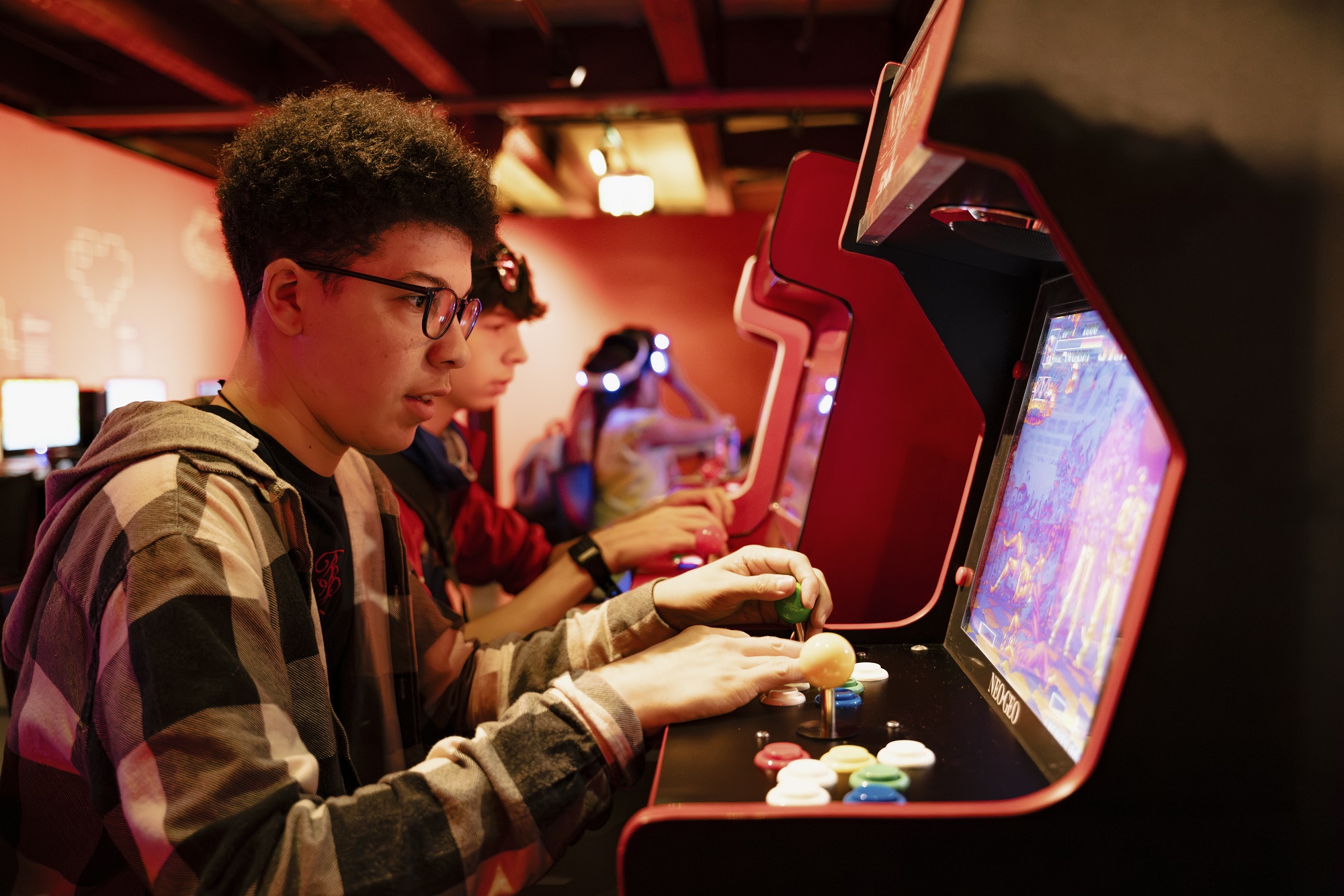 Image of a boy playing on a retro game in Power Up