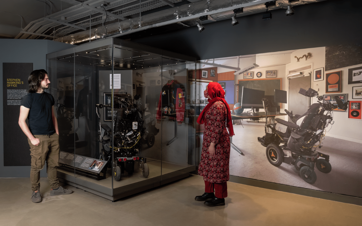 Two people explore the Stephen Hawking at Work exhibition.