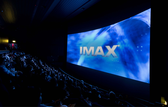An large cinema screen with text that says IMAX