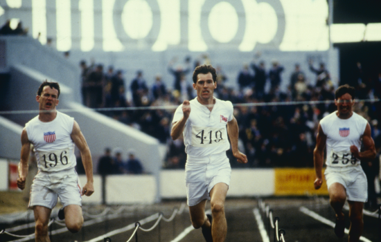 Three men sprinting towards the finish line at the 1924 Olympics