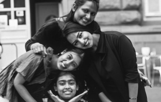 A group of young South Asian women smiling