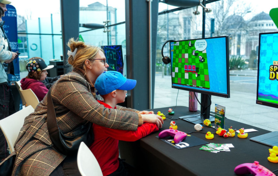 A mum helping her son with a game at Yorkshire Games Festival