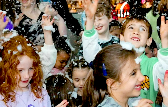 Children playing in foam