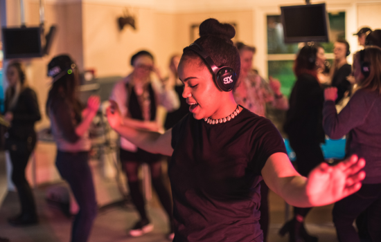 A woman dancing with headphones during a silent disco at the national science and media museum