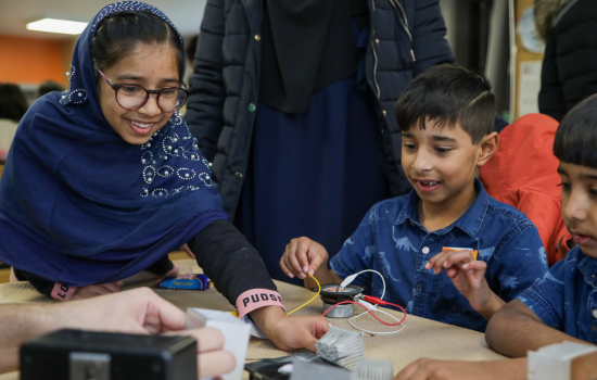 Two children creating a circuit