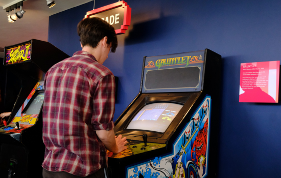 A person playing an arcade game in Power Up