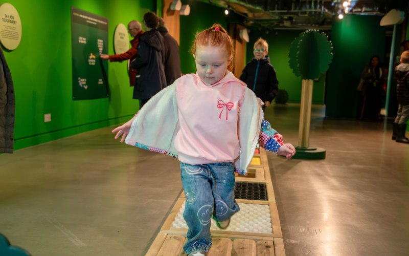 A child running along an area in Living Dots at the National Science and Media Museum