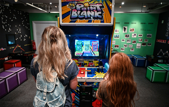 A woman and young girl playing Point Blanc in Games Lounge