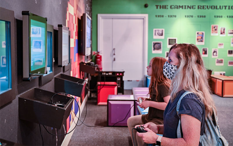 A woman and a young girl playing on games in Games Lounge