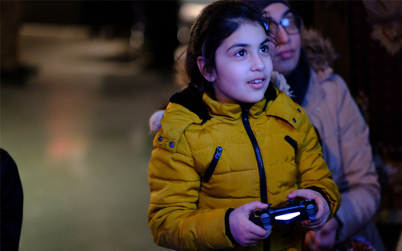 A young girl playing a videogame