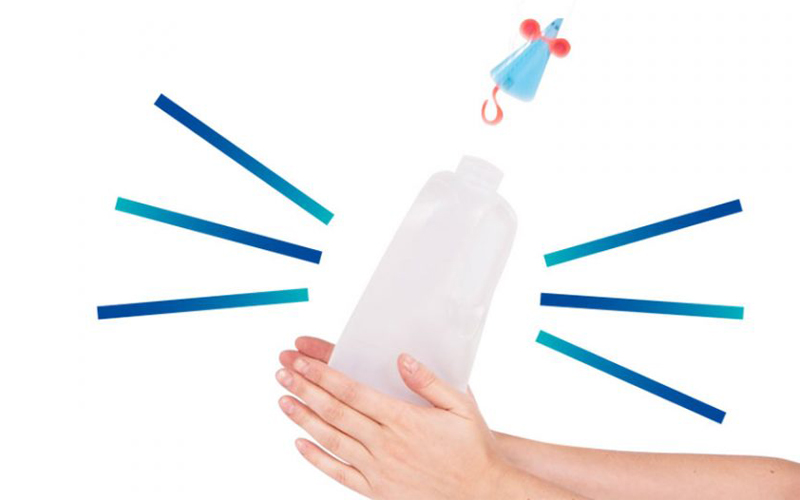 Small plastic mouse being launched from a milk bottle