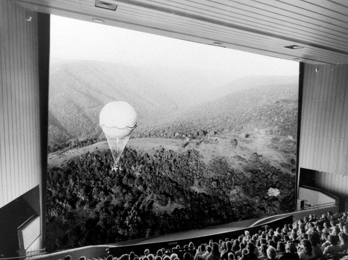 A black and white photograph of the IMAX at the National Science and Media Museum showing a documentary about air travel