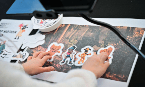 A close up of a child's hands doing a Shaun the Sheep animation activity