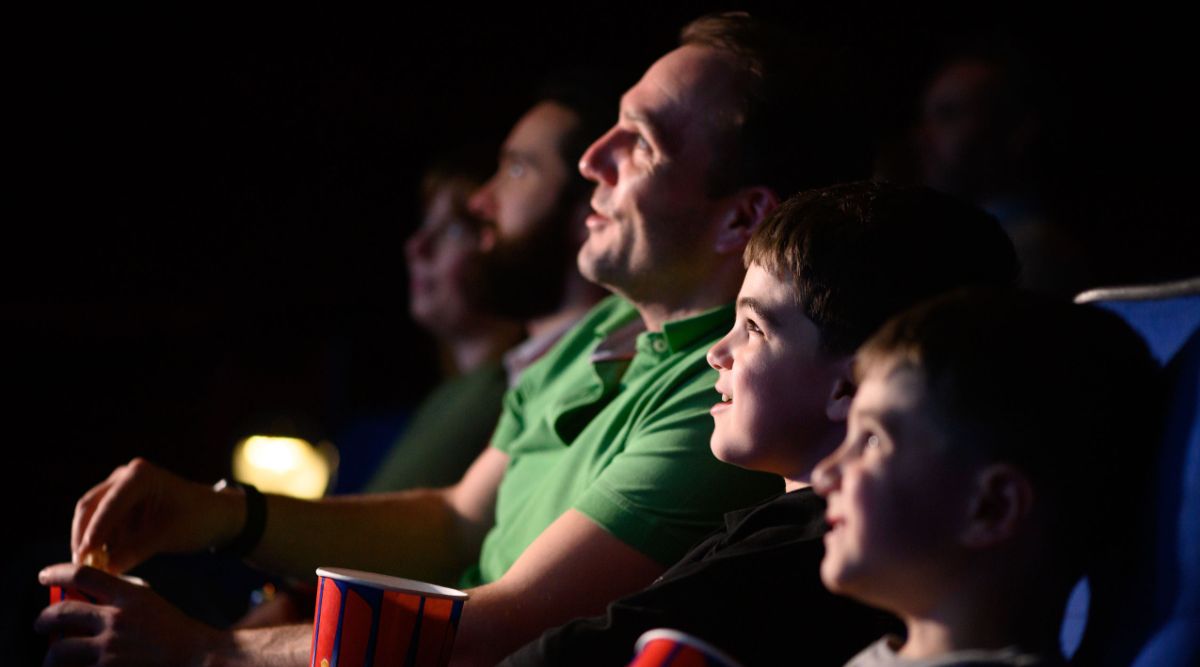 A family enjoying a film in the cinema