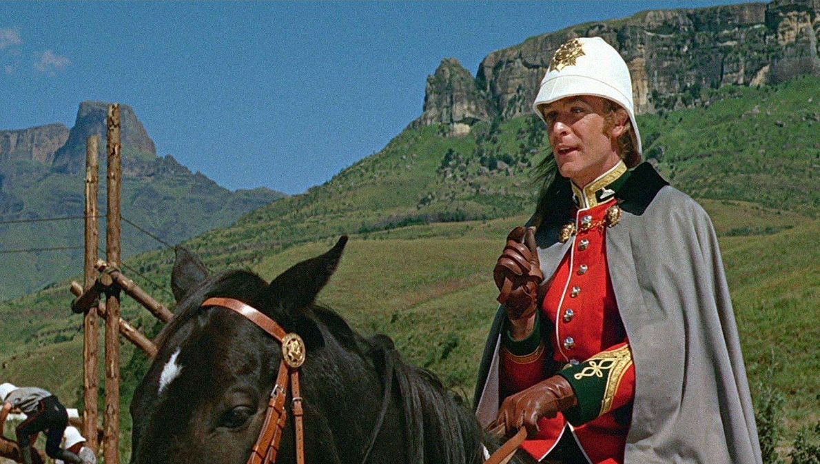 Scene from Zulu showing Michael Caine on horseback, set against a mountainous landscape.