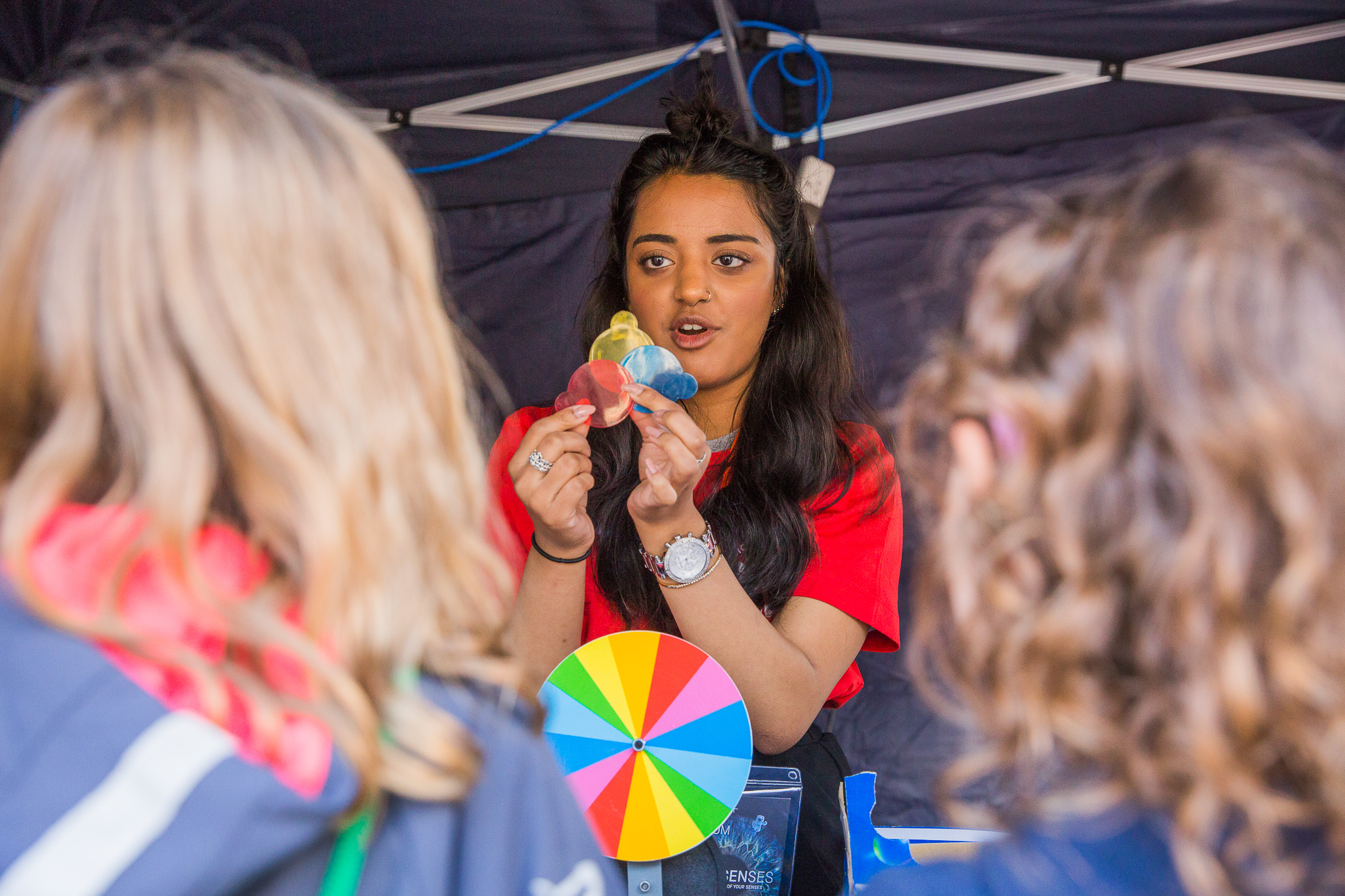 A woman demonstrating colour wheels to children at Bradford Science Festival