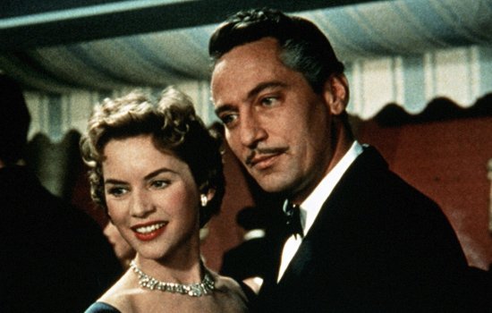 A smartly dressed man and woman stand together