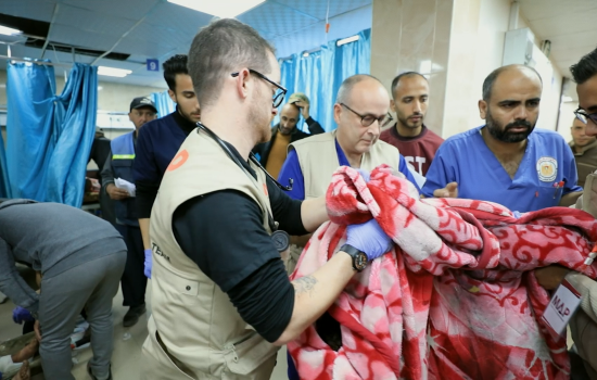 Still from Life Support; doctors and medical staff hold a blanket in a hospital in Gaza