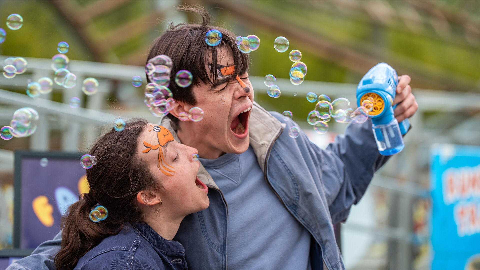 A still from The Summer Book in which Glenn Close embraces a young girl as the sun shines behind them.