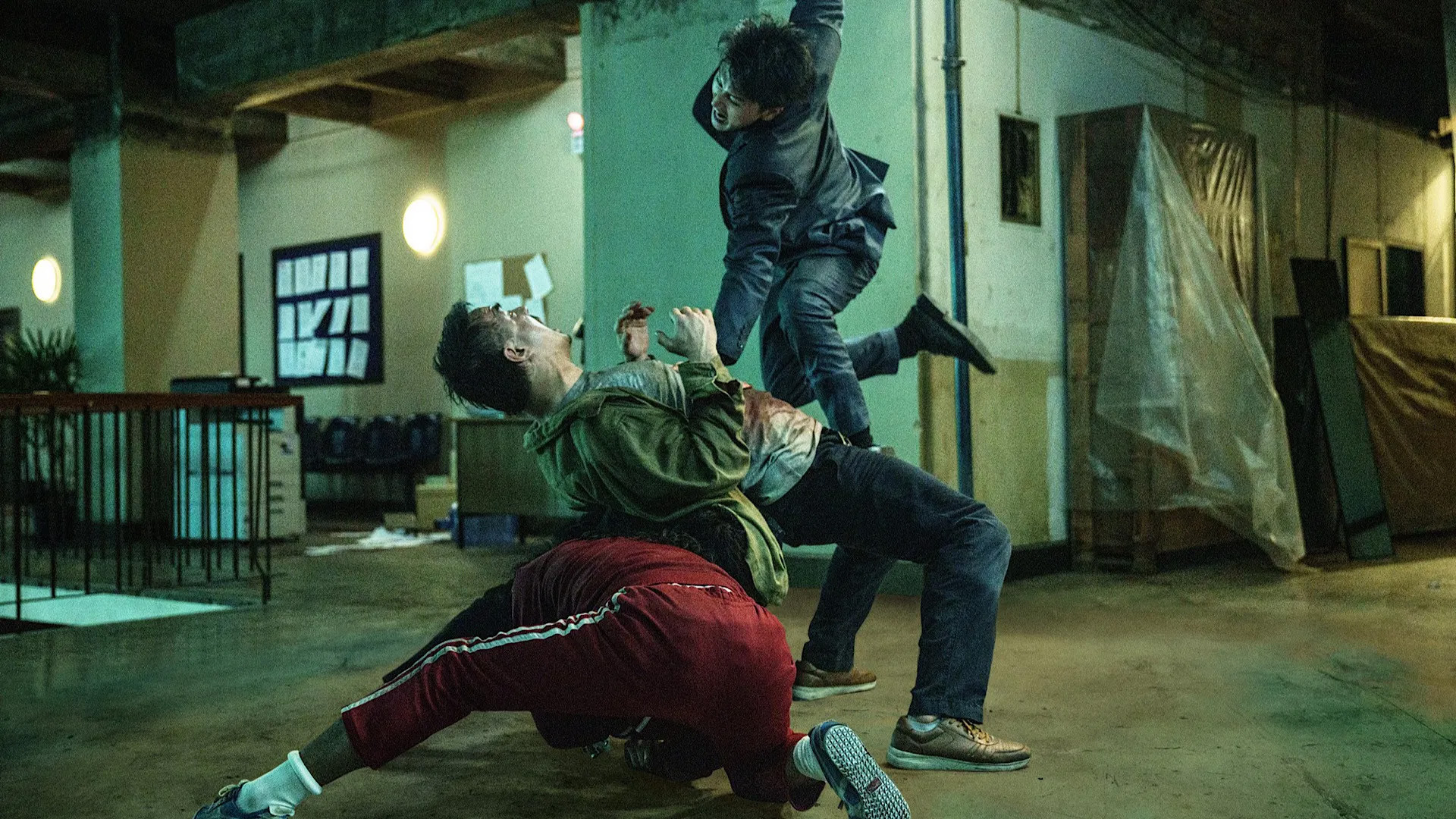 Still from The Furious, three people are centre of the frame mid-brawl.