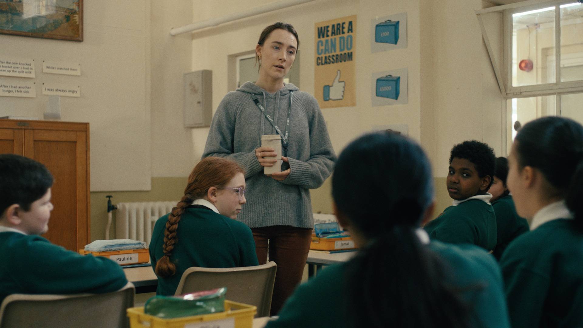 Saorise Ronan stands in the middle of a classroom, mid-conversation with a student