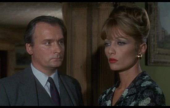 A man stares intensely at a woman's profile.