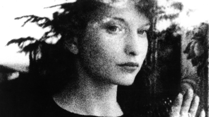 A black and white image of a woman staring out a window.