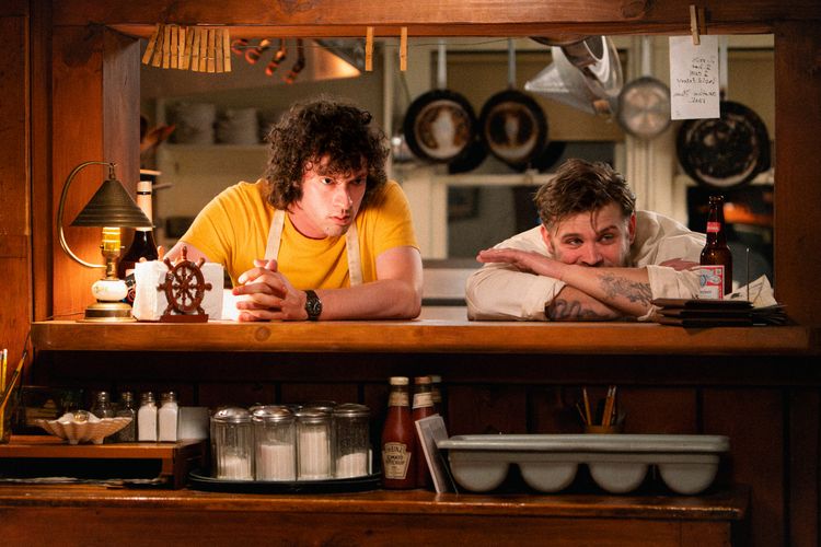 Dominic Sessa and Leo Woodall stare out from a kithcen.