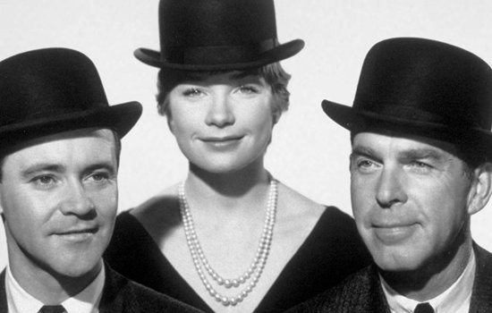 A black and white image of two men and a woman wearing bowler hats.