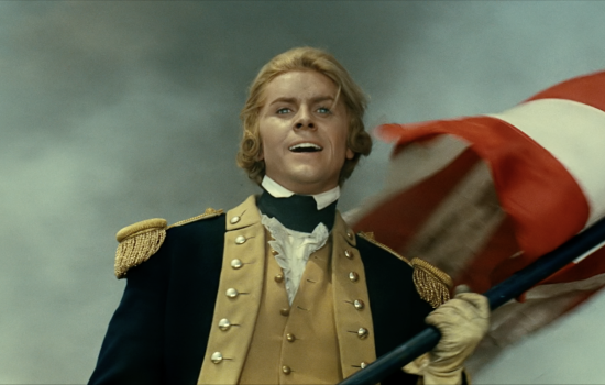 A blonde man wears a historical army uniform,