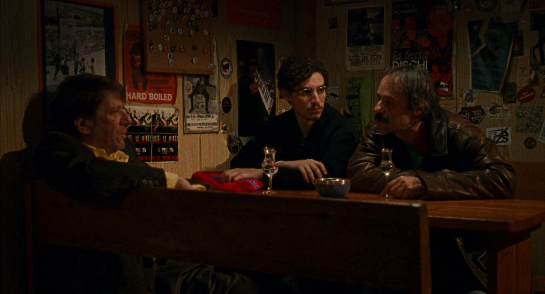 A still from The Last One for the Road featuring three men sat in a bar.