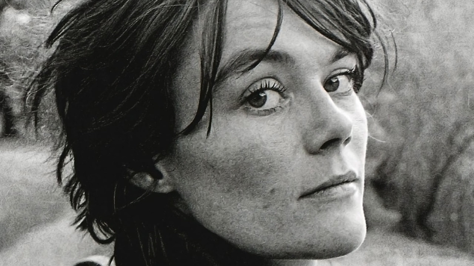 A black and white image of Tish Murtha staring directly at the camera.
