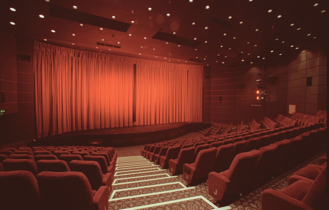 An image of Pictureville Cinema, featuring the iconic bright red curtains over the cinema screen.