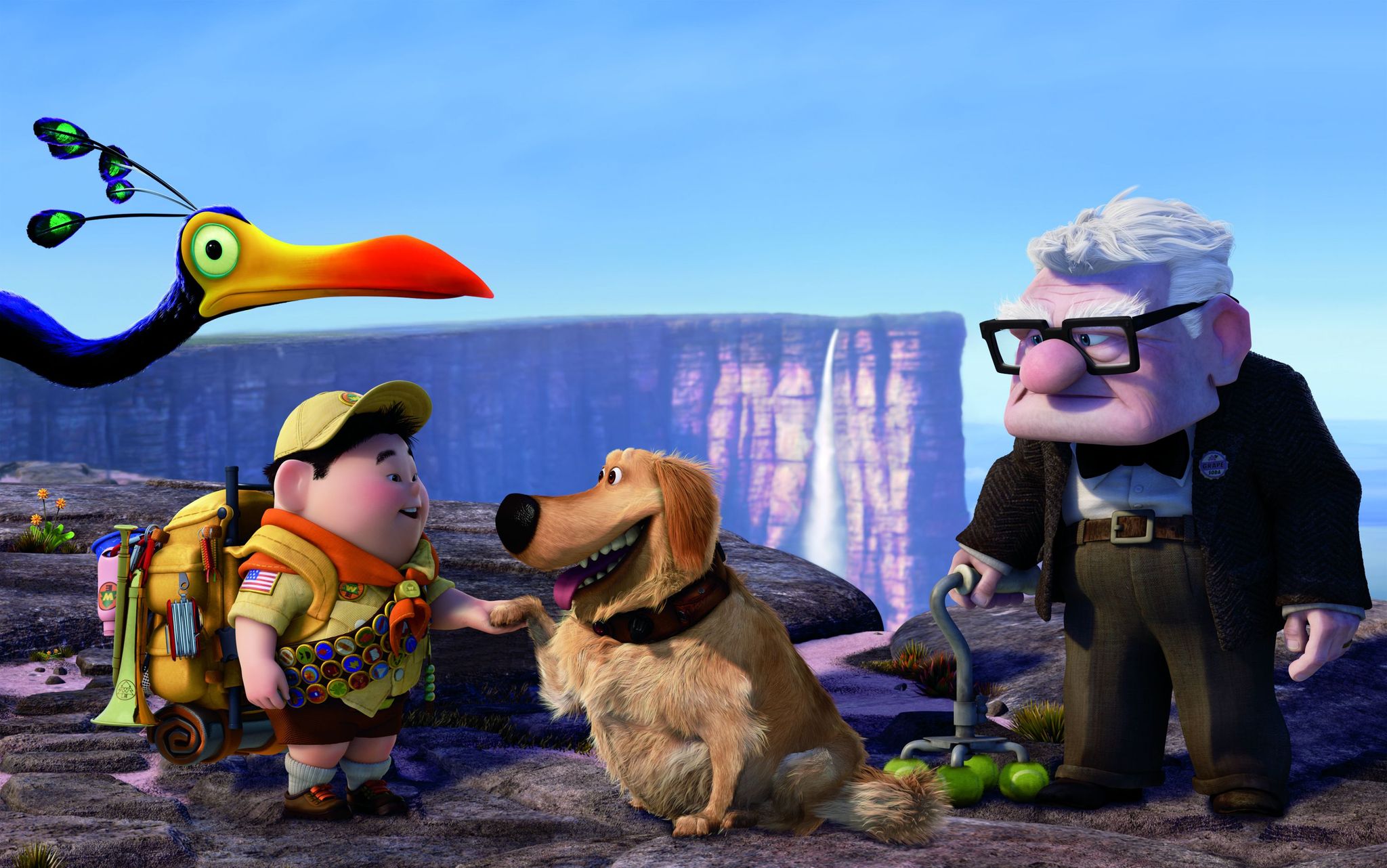 An animated image from Up of an old man, a dog, a young boy scout and a large exotic bird all stand together on top of a scenic cliff.