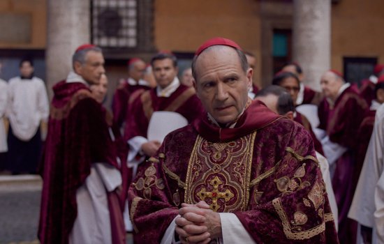 Ralph Fiennes wears religious clothing.