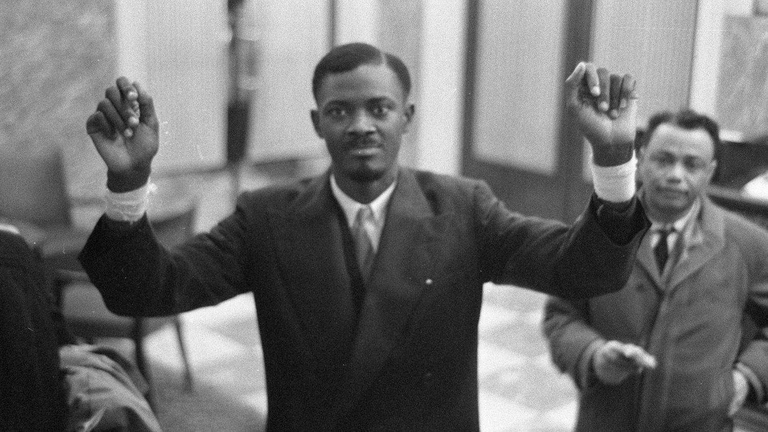 A black and white image of a man and woman standing side by side.