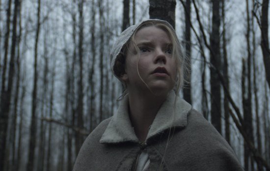 A young girl looks around a dark wood.