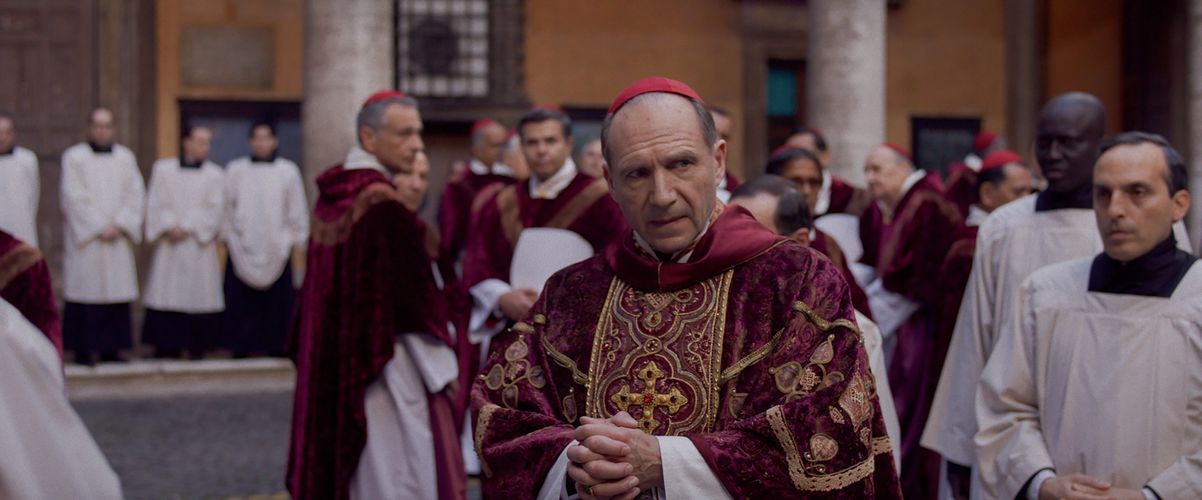 Ralph Fiennes wears religious clothing.