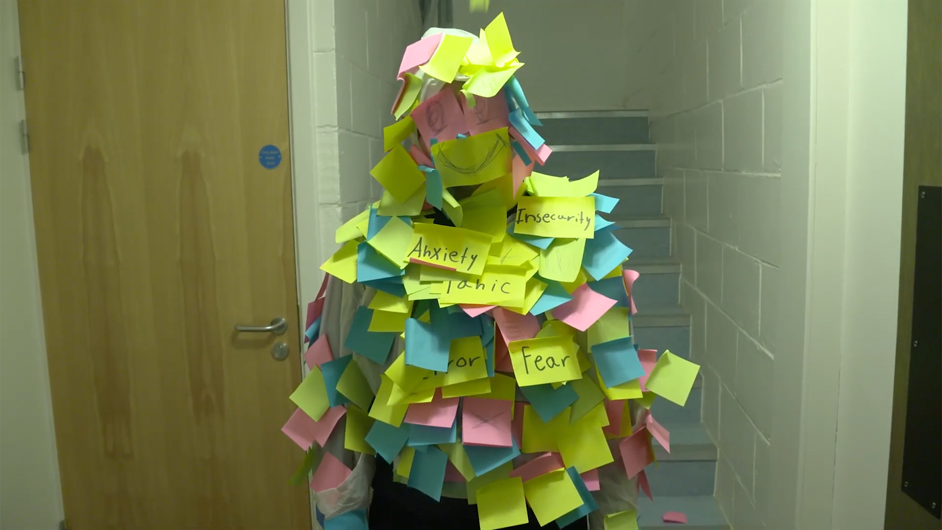 A person is covered in sticky notes.