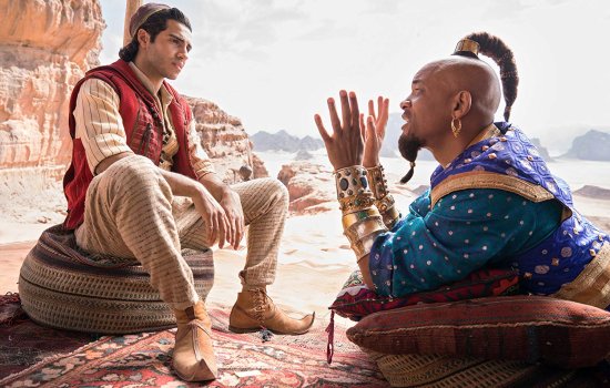 A young man look quizzically at a Genie, dressed in a colourful purple outfit and gesturing at the young man.