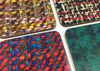 Four coasters for hot drinks are pictured in different prints of Bernat Klein's fabric designs. 