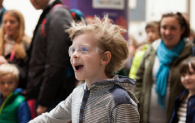 A young visitor interacts with a wind machine. 