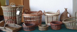 A collection of willow baskets lined up on a table. 