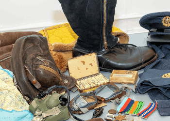 A selection of objects related to the Second World War are laid out on a table 