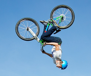 A cyclist spins in the air at a previous event at the National Museum of Flight.