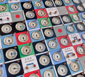 The Hunterston nuclear power station panel, showing lots of dials on red, blue, green and black squares on a grey machine.