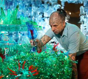 Artist George Nuku adds the finishing piece to his installation, Bottled Ocean 2123